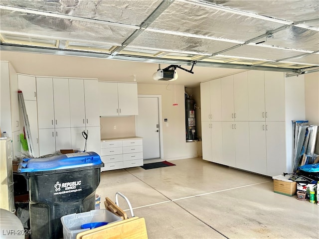 garage featuring strapped water heater and a garage door opener