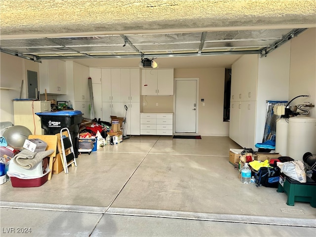 garage with a garage door opener and electric panel