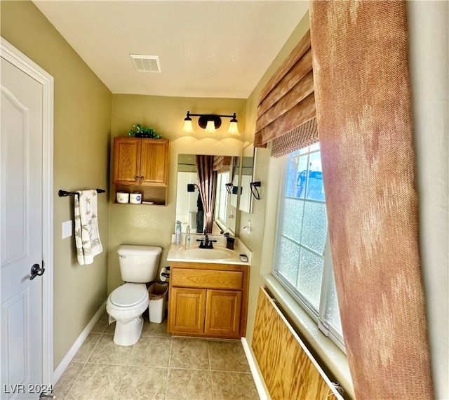 bathroom with tile patterned flooring, vanity, and toilet