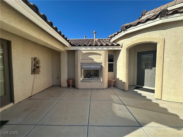 view of patio / terrace featuring exterior fireplace