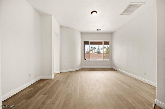 unfurnished room with light hardwood / wood-style flooring