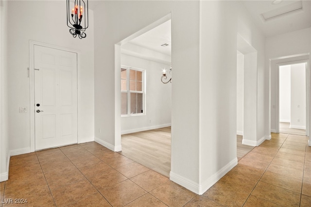 tiled entryway featuring a chandelier