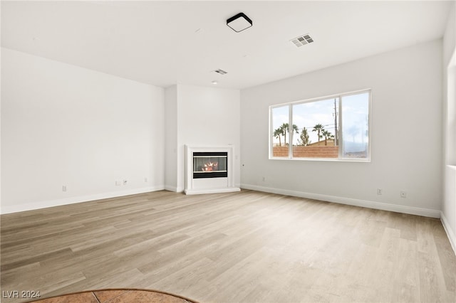 unfurnished living room featuring light hardwood / wood-style floors