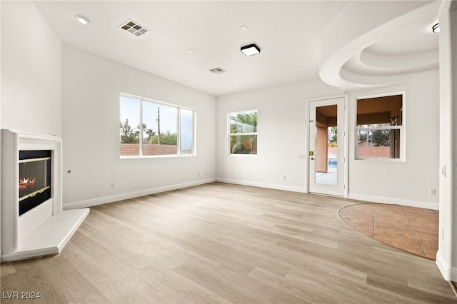 unfurnished living room featuring light hardwood / wood-style floors