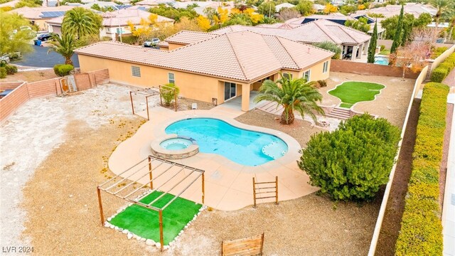 view of swimming pool featuring a patio area and an in ground hot tub