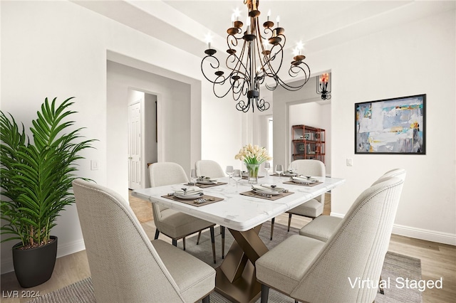 dining area featuring hardwood / wood-style floors and a chandelier