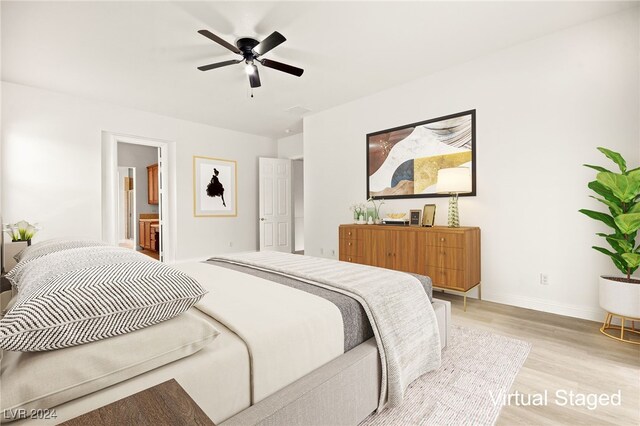 bedroom featuring ensuite bath, ceiling fan, and light hardwood / wood-style flooring