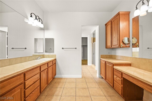 bathroom with tile patterned floors, vanity, and walk in shower