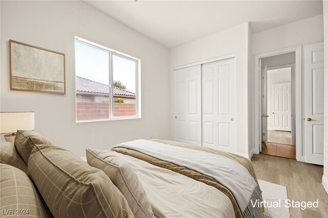 bedroom with a closet and light hardwood / wood-style floors