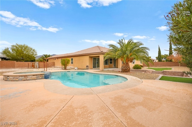 view of pool featuring an in ground hot tub and a patio