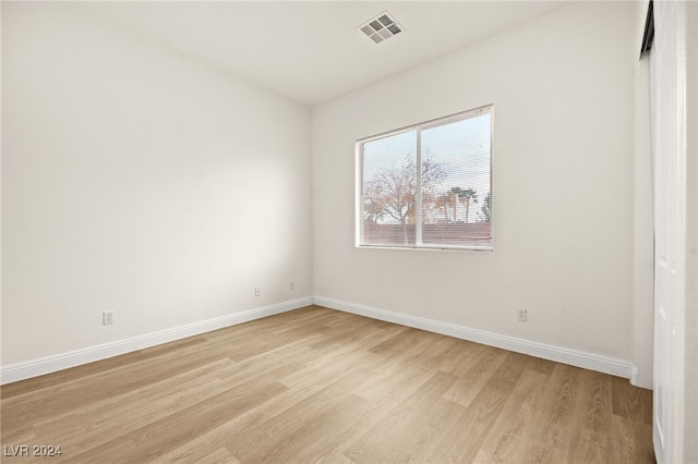 empty room with light hardwood / wood-style flooring