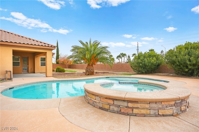 view of swimming pool with an in ground hot tub and a patio area