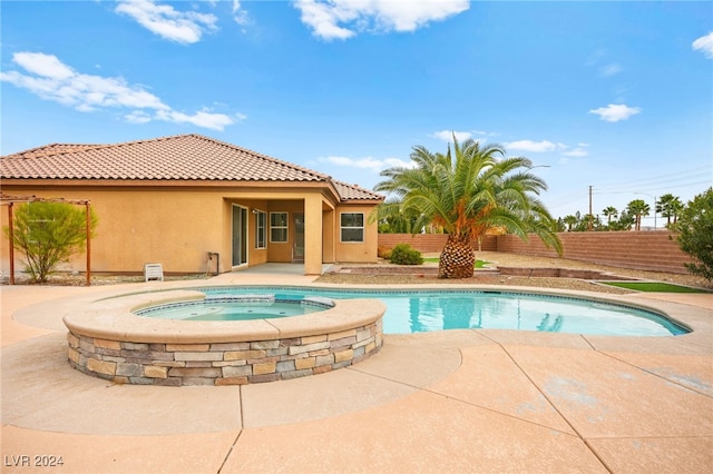 view of swimming pool with an in ground hot tub