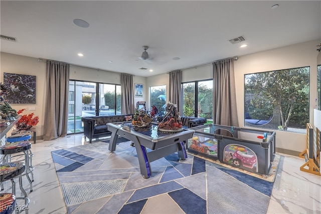 playroom with a wealth of natural light, french doors, and ceiling fan