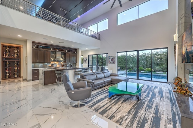 living room featuring a towering ceiling and plenty of natural light