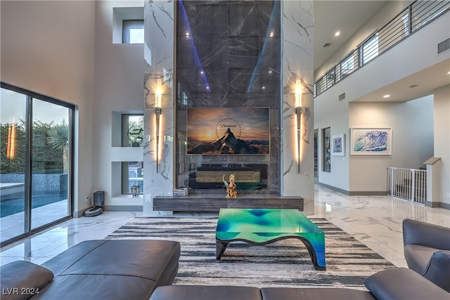 living room with a towering ceiling and a wealth of natural light