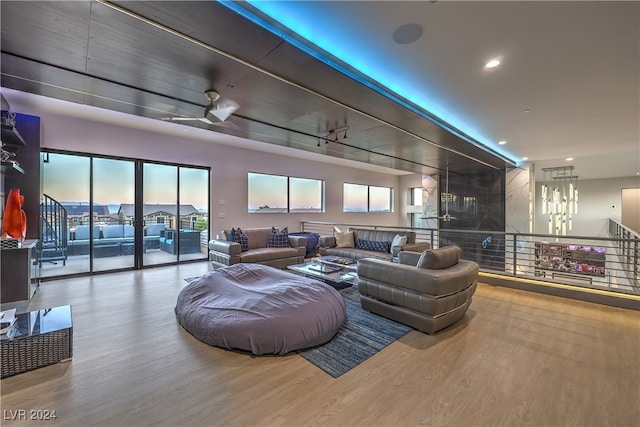 living room featuring hardwood / wood-style floors and ceiling fan