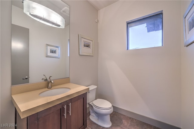 bathroom featuring tile patterned floors, vanity, and toilet