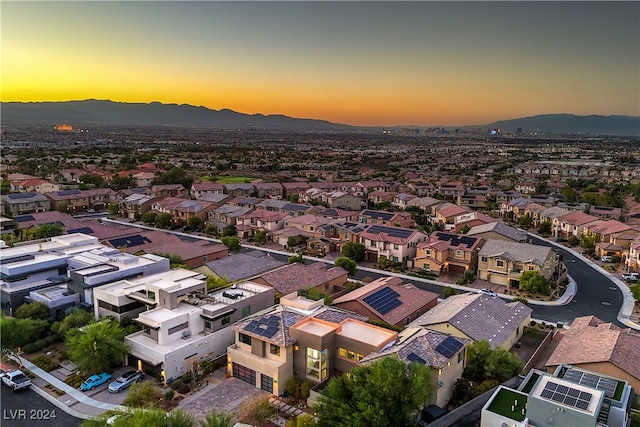 aerial view at dusk featuring a mountain view