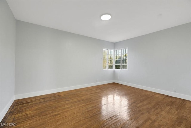 spare room featuring wood-type flooring