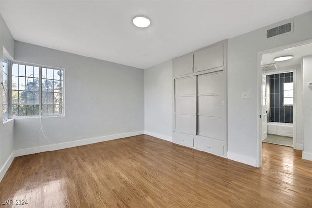 unfurnished bedroom featuring hardwood / wood-style flooring