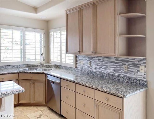 kitchen with sink, tasteful backsplash, stainless steel dishwasher, light brown cabinetry, and light tile patterned flooring