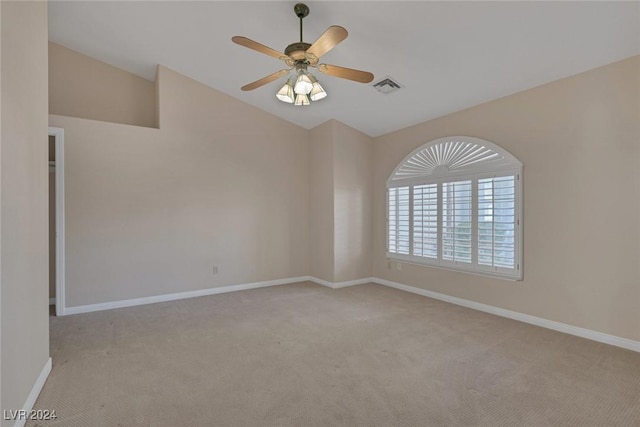 empty room with ceiling fan and light carpet