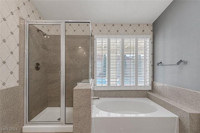 bathroom with shower with separate bathtub