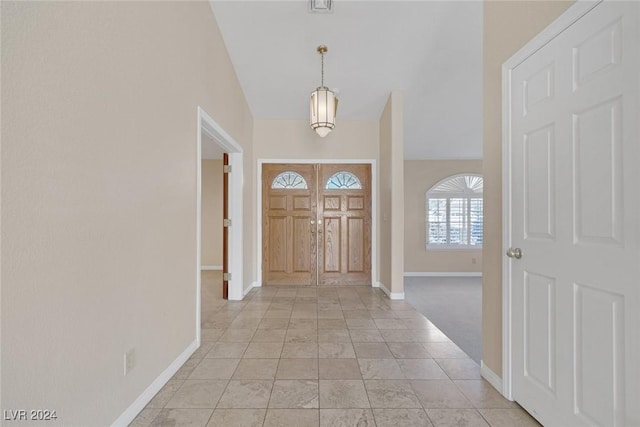 entrance foyer with high vaulted ceiling