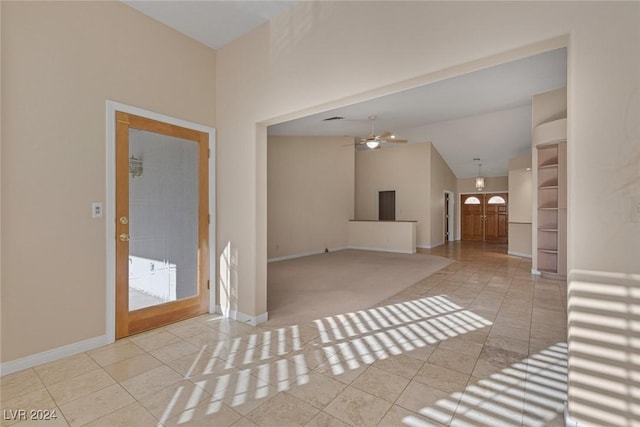 interior space featuring ceiling fan and vaulted ceiling