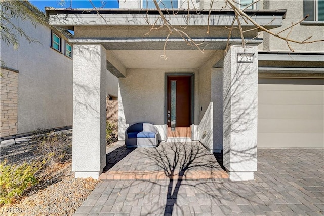 doorway to property with a garage