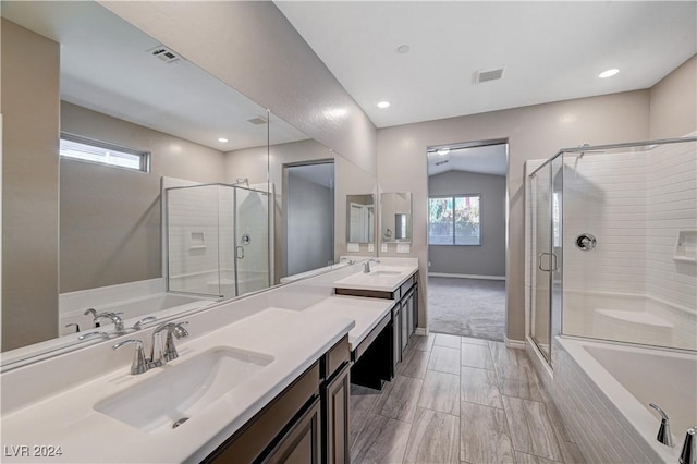 bathroom featuring vanity, vaulted ceiling, and plus walk in shower