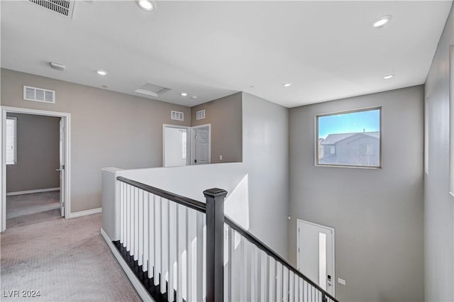 hallway featuring light carpet