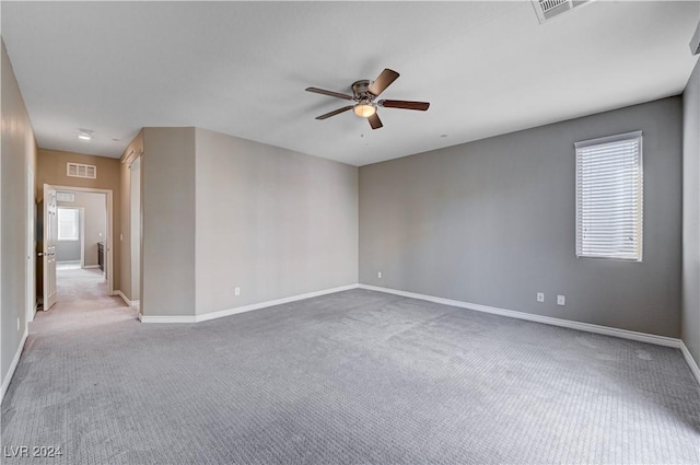 carpeted empty room featuring plenty of natural light and ceiling fan