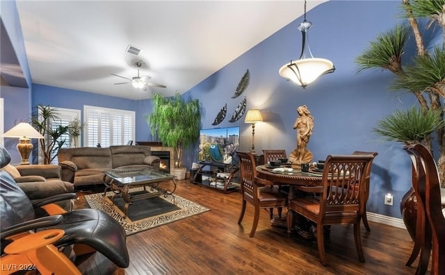 living room featuring ceiling fan and dark wood-type flooring