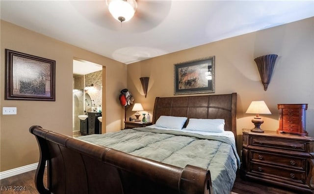 bedroom with ceiling fan, dark hardwood / wood-style flooring, and ensuite bath