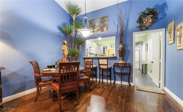 dining space with dark hardwood / wood-style flooring