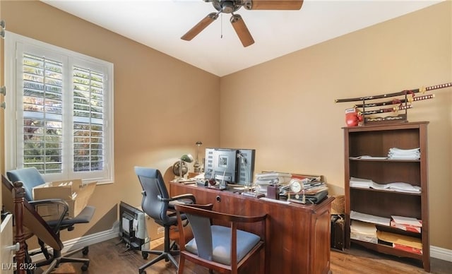 home office featuring ceiling fan, wood-type flooring, and a wealth of natural light