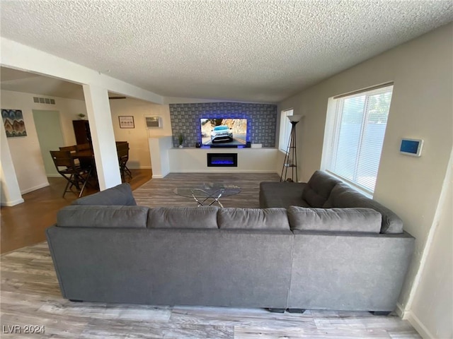 living room featuring a textured ceiling and hardwood / wood-style flooring