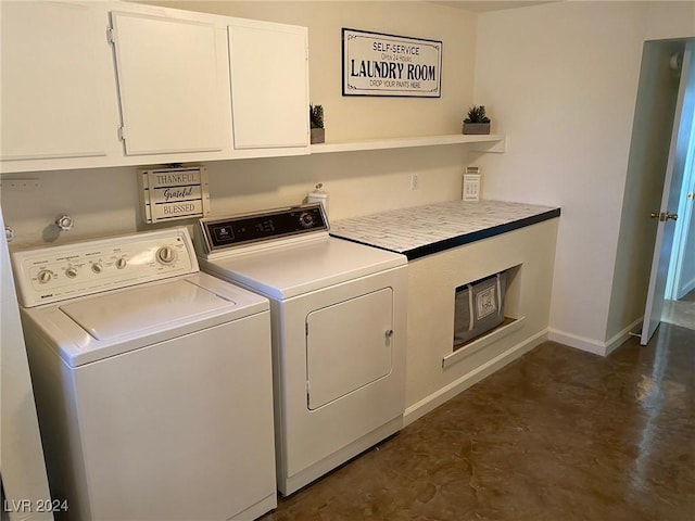 laundry room with cabinets and washer and clothes dryer