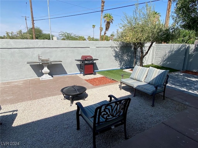 view of patio featuring area for grilling and an outdoor living space with a fire pit