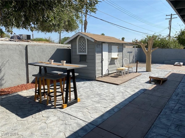 view of patio featuring a storage shed