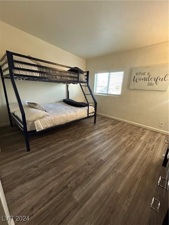 unfurnished bedroom with dark hardwood / wood-style flooring