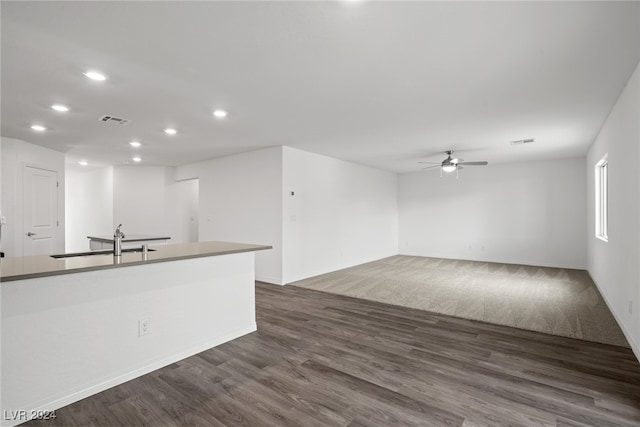 kitchen with ceiling fan, dark wood-type flooring, and sink