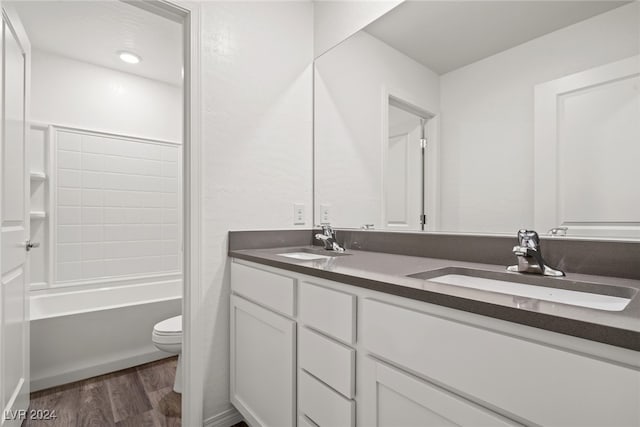 full bathroom with hardwood / wood-style floors, vanity, toilet, and tub / shower combination