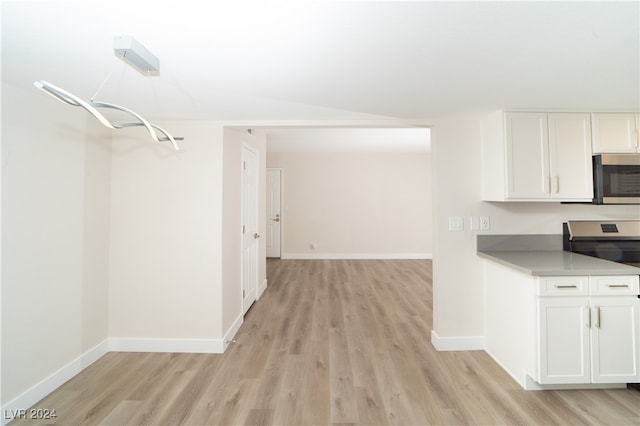 kitchen featuring range, white cabinetry, and light wood-type flooring