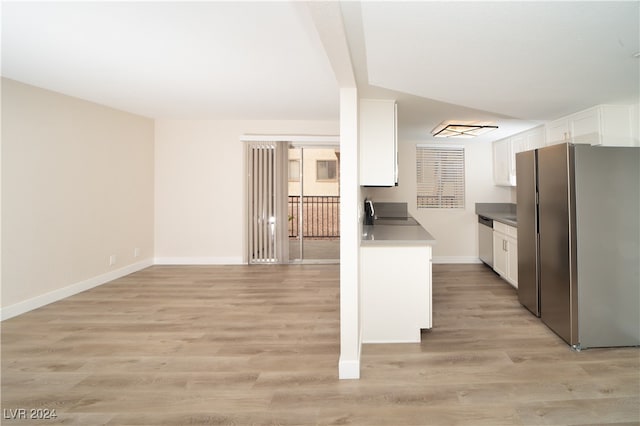 kitchen featuring appliances with stainless steel finishes, light wood-type flooring, and white cabinetry