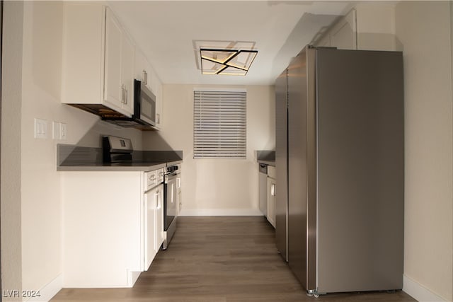 kitchen featuring white cabinets, dark hardwood / wood-style flooring, and stainless steel appliances