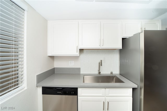 kitchen with white cabinets, appliances with stainless steel finishes, and sink