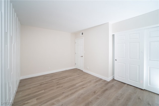 empty room with light hardwood / wood-style flooring